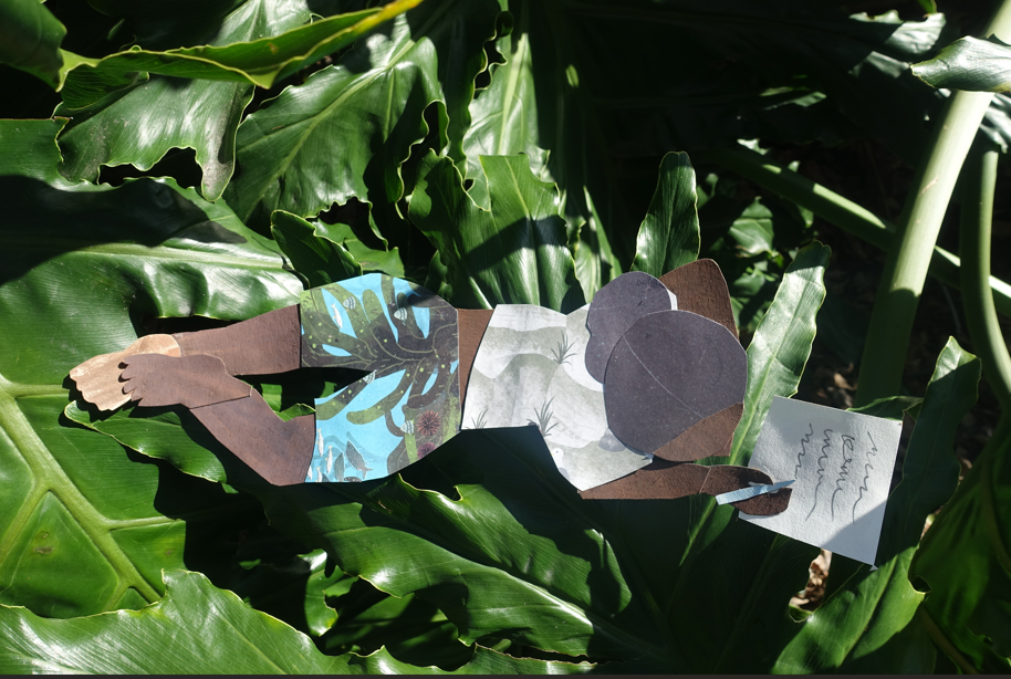 A paper collage of a person lying on large green leaves, reading a letter. The figure has dark skin, a gray bun, patterned shorts, and is surrounded by sunlight and leafy shadows.